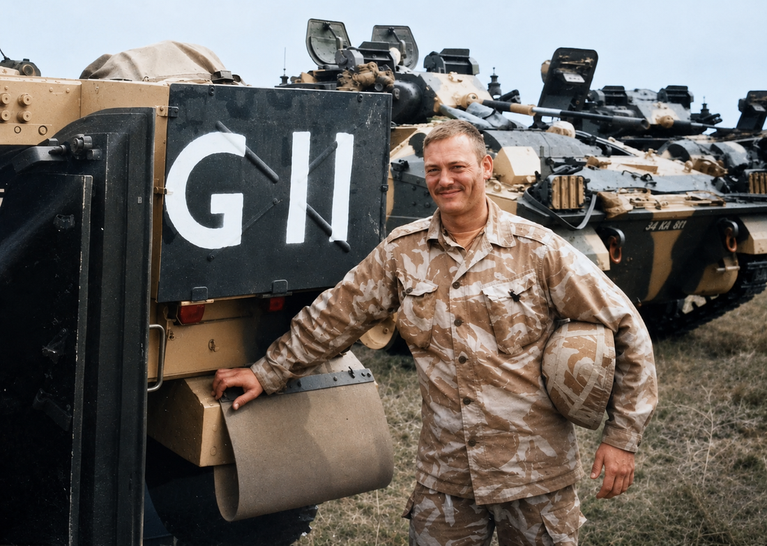 Darren Gray Owner of Cleared Hot in Desert Camo next to a military vehicle.